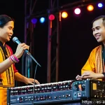 동남아 퓨전 음악 장르 분석 - A vibrant Southeast Asian music festival scene at night, featuring diverse musicians on stage blendi...